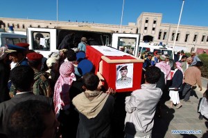 Yemeni soldiers put coffins of those who were killed in attacks on the defense ministry, into a vehicle in Sanaa, Yemen, on Dec. 9, 2013. The Yemeni defense ministry was attacked by al-Qaida militants on Dec. 5, which has left 56 killed and over 200 others injured.  /Xinhua/Mohammed Mohammed)