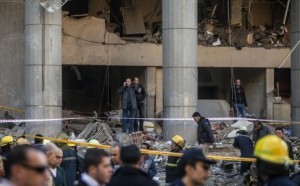 Egyptian emergency personnel inspect the site of a car bomb explosion outside the Cairo police headquarters on Jan. 24. /AFP