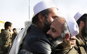 Afghan men hug each other after being released from prison on Jan. 3.  /AP/Ahmad Jamshid
