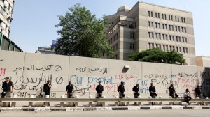 Security personnel stand guard near a wall with graffiti at the U.S. embassy in Cairo.  /Reuters