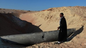 A Bedouin man looks at a gas pipeline that was hit by a RPG in North Sinai. /Reuters