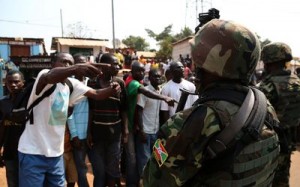 Men confront African Union soldiers in Bangui on Jan. 30 after residents had surrounded a convoy of Chadian Muslims fleeing the country. /Reuters
