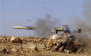 A Free Syrian Army fighter fires an anti-tank missile.  /Reuters