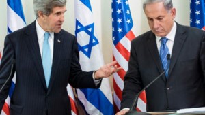 Israeli Prime Minister Benjamin Netanyahu listens as U.S. Secretary of State John Kerry makes a statement to the press before a meeting at Netanyahu's office in Jerusalem on Jan. 2.   /AFP/Getty Images/Brendan Smialowski 