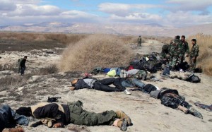 Syrian soldiers inspect the bodies of opposition fighters after an army ambush in the eastern Ghouta area of Damascus, in a photograph distributed by Syria's national news agency, SANA, on Feb. 26. /SANA