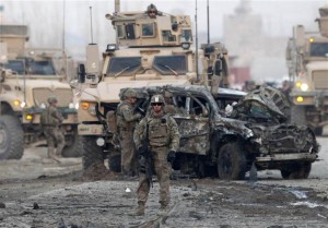 U.S. troops stand guard at the site of a suicide car bomb attack in Kabul on Feb. 10. Two U.S. civilian contractors were killed in the attack.