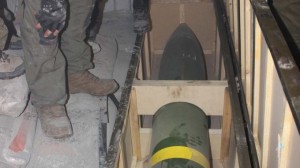 IDF soldiers inspect a missile found on board Klos-C in a commando operation Wednesday morning. The military says the ship was carrying an Iranian arms shipment headed for Gaza.  /IDF photo