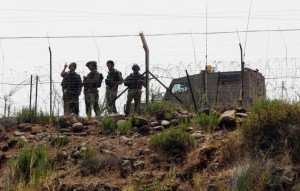 Israeli soldiers patrol the Lebanon-Israel border as seen from the southern Lebanese village of Wazzani. /Reuters/Ali Hashisho