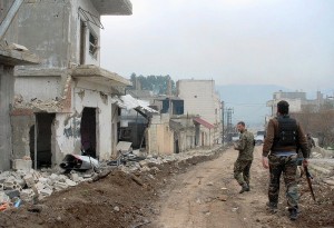 Syrian government forces patrol a street in the western town of Zara, near the Lebanese border, which had long been in rebel hands.  /AFP/Getty Images