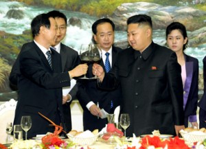 North Korea’s Kim Jong-Un lifts a glass with China’s Wang Jiarui in August 2012 in Pyongyang.  /AP/KCNA