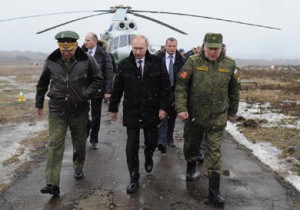Russian President Vladimir Putin walks with Defense Minister Sergei Shoigu, left, and commander of the Western Military District Anatoly Sidorov, right, at a military exercise near St.Petersburg, Russia on March 3. AP/RIA-Novosti/Mikhail Klimentyev, Presidential Press Service