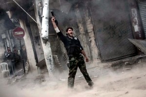 A fighter celebrates after firing a missile toward a building where Syrian troops were hiding. /Boston.com