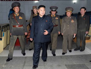 Hwang Pyong-So, right, joins Kim Jong-Un as he walks through an assembly hall at KPA Unit #318. /KCNA