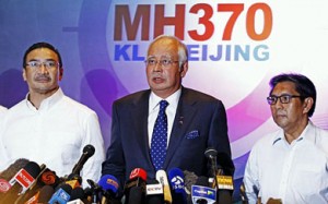 Malaysian Prime Minister Najib Abdul Razak, center, with two senior officials at a March 15 press conference.  /EPA
