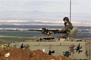 A Jordanian soldier stands guard in his tank at the Jordan-Syrian border near Mafraq.  /Reuters
