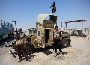 ISIL fighters with a captured Humvee.  /AP