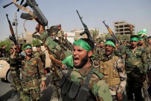 Volunteers in the newly formed "Peace Brigades" raise their weapons and chant slogans against the al-Qaida-inspired Islamic State of Iraq and the Levant during a parade in the Shiite stronghold of Sadr City, Baghdad on June 21.  /AP/Khalid Mohammed