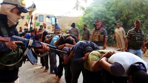 An image uploaded on June 14, 2014 on the jihadist website Welayat Salahuddin allegedly shows militants of the Islamic State of Iraq and the Levant (ISIL) capturing dozens of Iraqi security forces members prior to transporting them to an unknown location in the Salaheddin province ahead of executing them.  /AFP