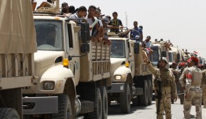 Army officers direct truckloads of Iraqi volunteers in Baghdad.  /Reuters