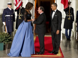 First Lady Michelle Obama greets French President Francois Hollande to a state dinner in his honor at White House in February.  /AP