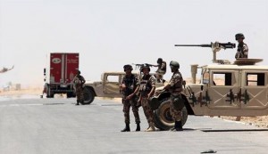 Jordanian soldiers stand guard near their military vehicles at the Al-Karameh border point with Iraq on June 25.
