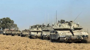 Israeli tanks, a bulldozer and armored personnel carriers (APC) roll near Israel's border with the Gaza Strip.  /AFP/Jack Guez