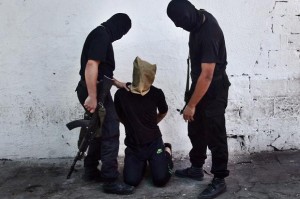 Hamas militants grab a suspected spy for Israel before executing him on Aug. 22.