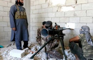 Rebel fighters prepare to fire a weapon towards Assad regime forces.