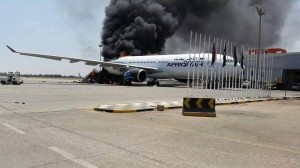 A plane engulfed in flames at Tripoli International Airport.