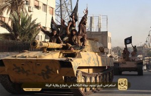 ISIL fighters drive tanks through Raqqa, Syria.  /Twitter