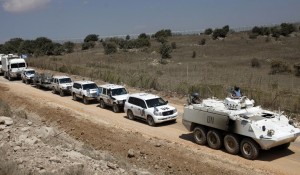 A convoy of United Nations Disengagement Observer Force vehicles is seen as it leaves the Syrian side of the Golan Heights into Israel on Sept. 15.  /AFP/Jalaa Marey