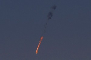 A Syrian fighter jet is seen in flames after it was hit by the Israeli military over the Golan Heights.  /AFP/Jalaa Marey