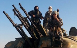 ISIL fighters on top of a captured military vehicle with anti-aircraft guns in Raqqa, Syria. /Raqqa Media Center/AP
