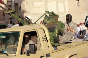 An ISIL fighter sits in a truck with an anti-aircraft gun.  /Reuters