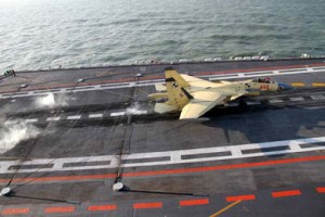 A J-15 fighter jet is slowed by an arresting device as it lands on the Liaoning aircraft carrier.  /Li Tang/China Daily