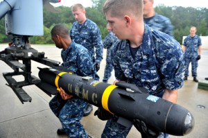 U.S. Navy aviation ordnancemen with a Hellfire missile. / U.S. Navy photo by Mass Communication Specialist 3rd Class Scott A. Raegen