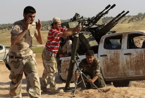Free Syrian Army (FSA) fighters fire a mortar on July 9. / Khalil Ashawi / Reuters