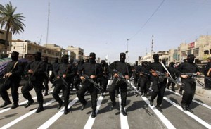 Mahdi fighters in military parade on the streets of Baghdad.  / Reuters 