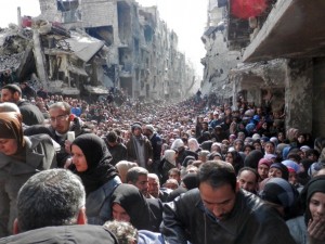 Syrians await humanitarian aid at the Yarmouk refugee camp. /United Nation Relief and Works Agency via Getty Images