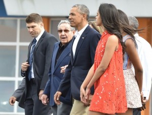 President Barack Obama with Cuba's Raul Castro walk to their plane at Jose Marti international airport in Havana, bound for Argentina. / Nicholas Kamm, AFP