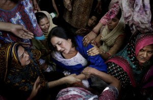 Pakistani women try to comfort a mother who lost her son in the Easter Sunday attack in Lahore. / K.M. Chaudary / AP