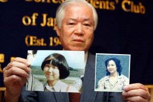 The father of Japanese abductee, Megumi Yokota, holds a picture of his daughter at 13 and then at 20 in North Korea. / Koichi Kamoshida / Getty
