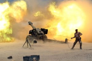 A member of the Iraqi security forces fires artillery during clashes with Isis militants near Fallujah on May 29. /Reuters
