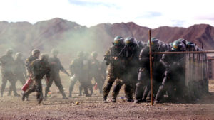 A unit from the Chinese People's Armed Police (PAP) participates in a drill with riot gear at a military base in Shigatse. / Reuters
