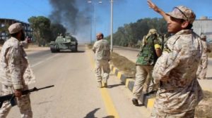 Soldiers from a force aligned with Libya's new unity government walk along a road during an advance on the eastern and southern outskirts of the Islamic State stronghold of Sirte, in this still image taken from video on June 9. /Reuters