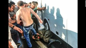 Civilians beat a Turkish soldier who participated in the attempted coup. /AP
