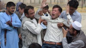 A victim's relative is overcome with grief at the site of the July 23 ISIL bombing in Kabul. /AFP