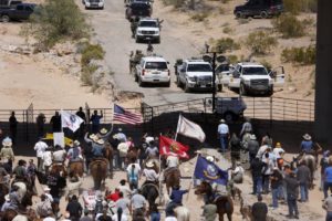 Protesters gather at the Bureau of Land Management's base camp, where cattle that were seized from rancher Cliven Bundy are being held, near Bunkerville, Nevada April 12, 2014. /Reuters