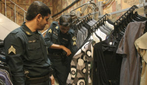 Iran's religious police with samples of inappropriate women's clothing. / Reuters