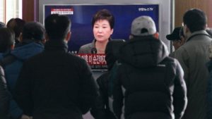 People watch a live broadcast of South Korean President Park Geun-hye addressing the nation at the Seoul Railway Station in Seoul on Nov. 29. /AP